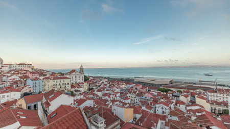 Panorama showing aerial view of Alfama in Lisbon timelapse during sunset.の写真素材