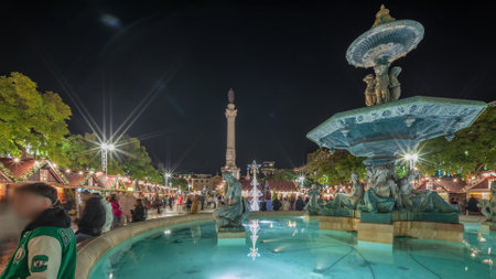 Panorama showing illuminated fountain with holiday decorations at the Rossio Christmas Market timelapse on Dom Pedro IV square. Lisbon, Portugalの写真素材