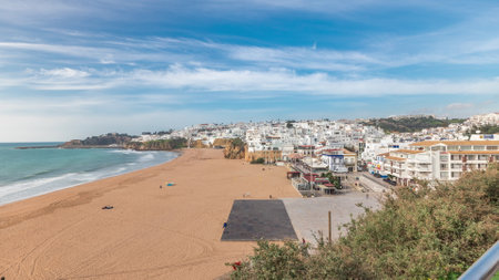Wide sandy beach and Atlantic ocean in city of Albufeira timelapse. Algarve, Portugalの写真素材