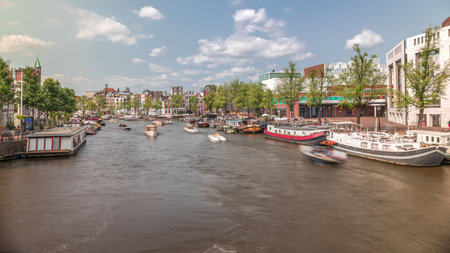 Boats floating near the National Opera music and theatre venue timelapse. Amsterdam, The Netherlandsの写真素材
