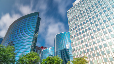Timelapse of modern office buildings. Glass skyscrapers with reflections and highlightsの写真素材