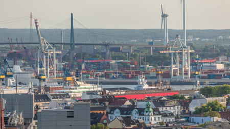 Aerial timelapse of Hamburg cargo port, showcasing container terminals, cranes and cargo ships on...