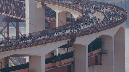 Running Lisbon half marathon crossing the 25 of April bridge over the Tagus river aerial view from above.の写真素材
