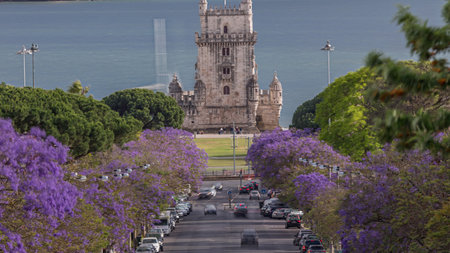 View of Avenida Torre de Belem timelapse, with cars and the Belem Tower in the background. Lisbon, Portugalの写真素材