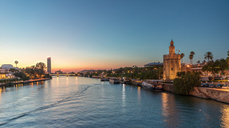 Guadalquivir River near Torre del Oro day to night timelapse in Seville, Spainの写真素材