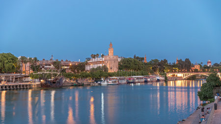 Torre del Oro day to night timelapse on Guadalquivir River in Seville, Spainの写真素材