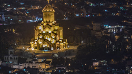 Illuminated Tsminda Sameba Cathedral or Holy Trinity Cathedral of Tbilisi aerial night timelapse....