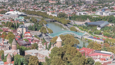 Aerial timelapse of the Bridge of Peace, a bow-shaped pedestrian bridge in Tbilisi, Georgiaの写真素材