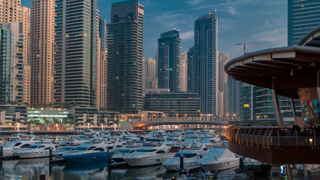 Dubai Marina at Blue hour night to day timelapse with yachtsの写真素材