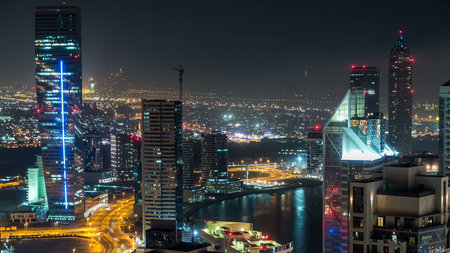 Aerial view of a big modern city at night timelapse. Business bay, Dubai, United Arab Emirates.の写真素材