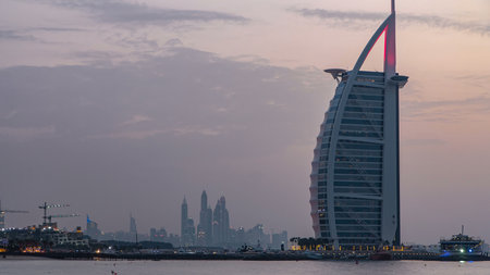 Dubai skyline with Burj Al Arab hotel day to night timelapse.