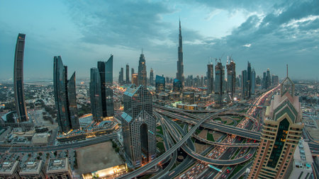 Modern skyscrapers and busy evening highways day to night timelapse in luxury Dubai city, Dubai, United Arab Emiratesの写真素材