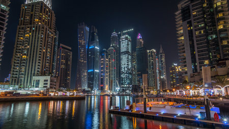 Dubai marina bay with yachts an boats night timelapse hyperlapseの写真素材