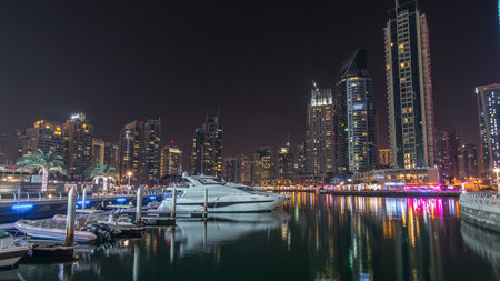 Dubai marina bay with yachts an boats night timelapse hyperlapseの写真素材