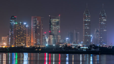 Skyscrapers at the Dubai Internet City illuminated at night timelapse. United Arab Emirates, Middle Eastの写真素材