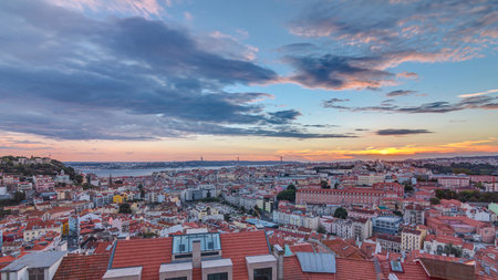 Lisbon at sunset aerial panorama view of city centre with red roofs at Autumn evening timelapse, Portugalの写真素材