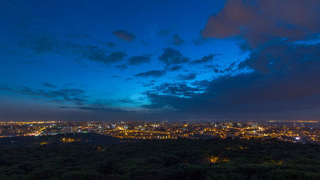 Panoramic view over Lisbon and Almada from a viewpoint in Monsanto night to day timelapse.の写真素材