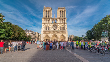 Front facade of cathedral of Notre Dame de Paris, with square full of people in front timelapse hyperlapseの写真素材