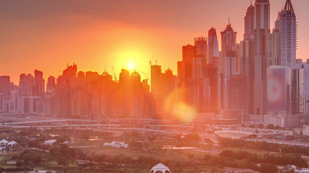 Dubai Marina skyscrapers and golf course sunset timelapse, Dubai, United Arab Emiratesの写真素材
