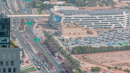 Skyline view of intersection traffic on Al Saada street near DIFC night timelapse in Dubai, UAE.