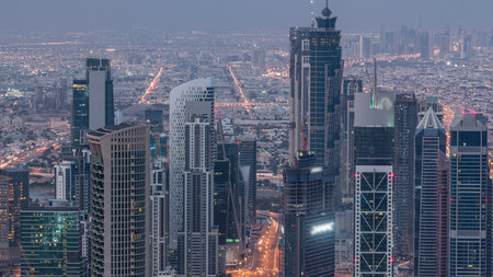 Dubai Downtown skyline futuristic cityscape with many skyscrapers and Burj Khalifa aerial night to...