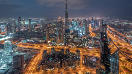 Dubai Downtown skyline futuristic cityscape with many skyscrapers and Burj Khalifa aerial night to day timelapse.の写真素材