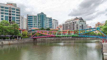 Alkaff Bridge on the Singapore River at Robertson Quay with dark gray clouds timelapse hyperlapse
