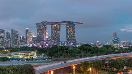 Aerial view after sunset with Singapore city skyline view from Marina barrage garden day to night timelapse.の写真素材