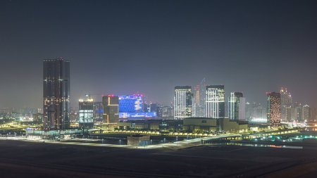 Buildings on Al Reem island in Abu Dhabi night timelapse from above.の写真素材