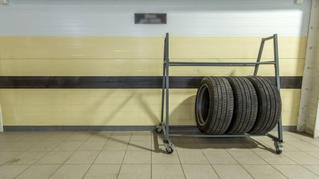 Car mechanic put tires from trolley to rack in auto repair service timelapse.の写真素材