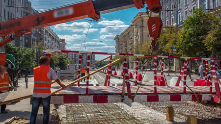 Orange construction telescopic mobile crane moving small pedestrian bridge timelapse.