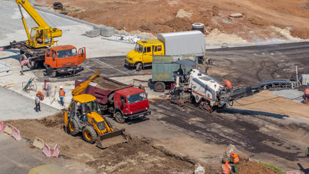 Aerial view of large road construction site with several industrial machines timelapse.