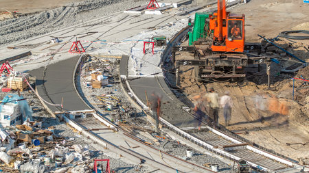 Concrete works for road construction with many workers and mixer timelapse