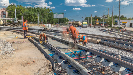 Pouring ready-mixed concrete after placing steel reinforcement to make the road by concrete mixer timelapse.の写真素材