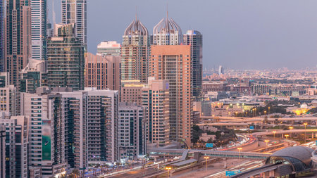 Dubai marina with traffic on sheikh zayed road panorama day to night timelapse lights turn on.の写真素材