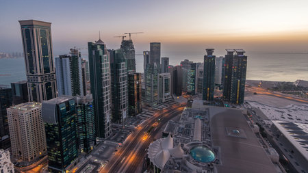 The skyline of the West Bay area from top in Doha night to day timelapse, Qatar.の写真素材