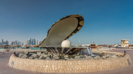 A fountain featuring an oyster with a gigantic pearl inside timelapse hyperlapse with the Doha skyline behind itの写真素材