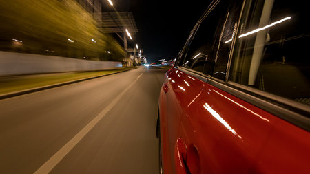 Drivelapse from side of car moving on a night avenue in city timelapse hyperlapse