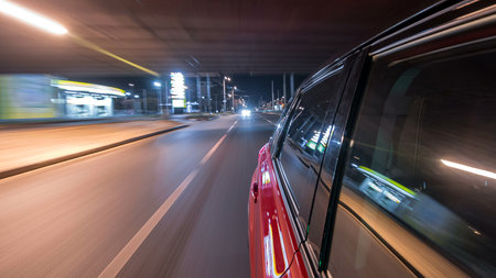 Drivelapse from side of car moving on a night avenue in city timelapse hyperlapse
