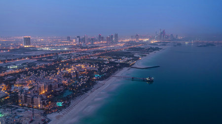 Skyline view of Dubai from night to day transition, UAE. Timelapseの写真素材