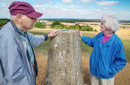 90 year old man takes his wife,who has severe sight loss to Danebury Ring in Wiltshire to get her out in nature and away from the confines of her house bound lifestyle.She has accute macular degeneration.の写真素材