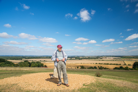 90 year old man takes his wife,who has severe sight loss to Danebury Ring in Wiltshire to get her out in nature and away from the confines of her house bound lifestyle.She has accute macular degeneration.の写真素材
