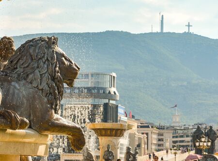 SKOPJE,REPUBLIC OF NORTH MACEDONIA-AUGUST 25 2018:Millennium Cross (background) overlooks the Statues and fountains at the Place next tothe Museum of Archaeology and Stone Bridge.のeditorial素材