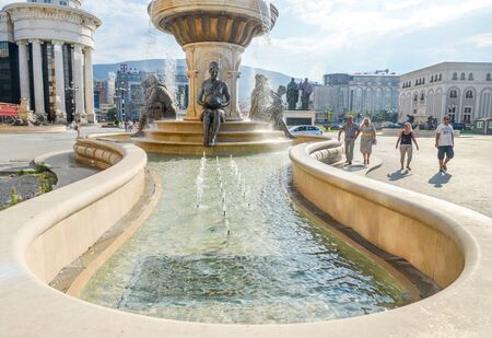 2018:SKOPJE,REPUBLIC OF NORTH MACEDONIA-AUGUST 25 2018:Statues and fountains at the Place next tothe Museum of Archaeology and Stone Bridge.のeditorial素材