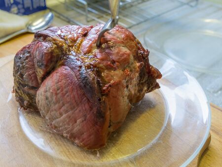 Steaming hot roasted joint of beef ready for carving before a Sunday lunch..の写真素材
