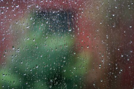 Showing blurred objects in the background,a back yard, after a typical Winter afternoon shower as the sun starts to re-emerge.の写真素材