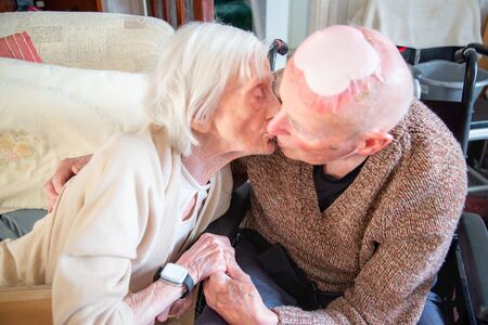Still in love in their 90's,together,both living and sleeping in the living room downstairs due to their health conditions and looked after by family and carers.の写真素材