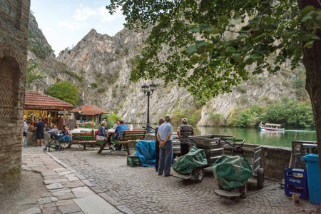 At Matka Canyon,near Skopje,as early evening approaches,people start to gather for a meal or drink next to the calm waters of Matka lake.のeditorial素材
