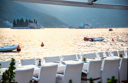 At sunset awaiting customers for an evening meal al fresco at a beautiful tourist spot along Bay of...