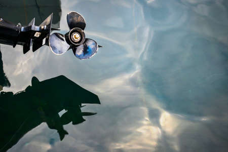 Bright steel propeller blades gleaming in the summer light just after sunset,over the calm waters of Kotor Bay.の写真素材
